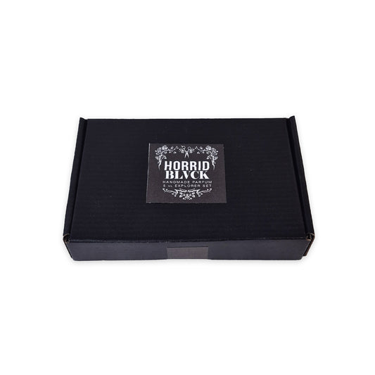 A black rectangular discovery box with a centered square label reading 'HORRID BLACK - Handmade Parfum - 5 ML Explorer Set' in white decorative text, photographed on a plain white background.